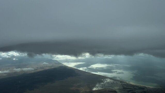 Aerial view while flying near mediterranean coast over Spain bellow a cumulus. Pilot point of view.
