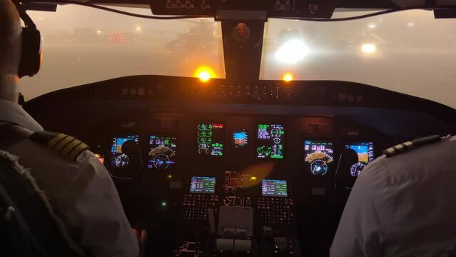 Jet cockpit view from inside in a heavy fog condition in the ramp before starting push-back maneuver.