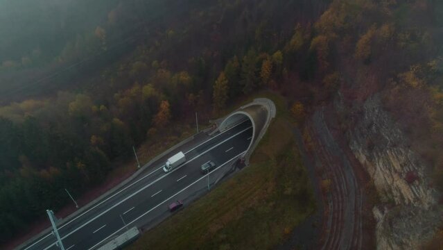Hrebec tunnel in the Moravska Trebova in the Czech Republic. Tunnel traffic resumed after reconstruction on a cold foggy autumn morning. Passing cars and trucks