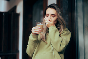 Woman Suffering a Toothache being Sensitive to Hot Drinks. Unhappy young person having a teeth sensitivity to cold or hot temperatures

 - obrazy, fototapety, plakaty