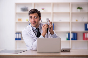 Young male doctor in telemedicine concept