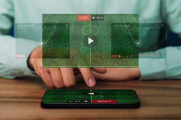 Man using a smartphone or mobile phone for watching live football streaming online on virtual screen, searching video on internet, concept of content online. - 548401012