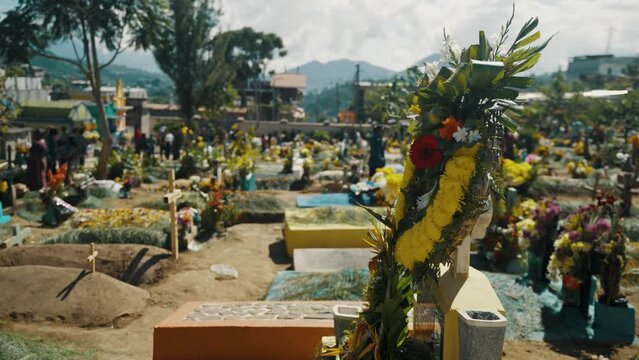 Beautiful Marigold Flower Arrangement Over Headstone On The Graveyards In Sumpango, Guatemala. Rotating Shot