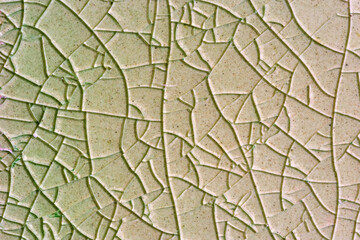 Close up to background and texture of stretch marks cracked on emerald green glazed tile. Scratches...
