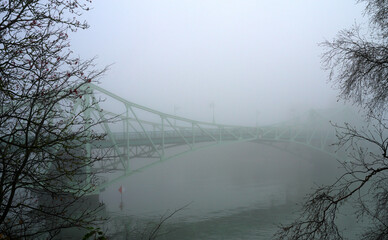 Ancient drawbridge in dense fog. Selective focus.