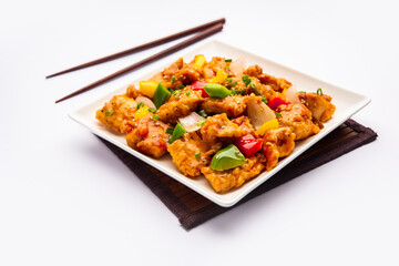 Chilli chicken which is a popular Indo-Chinese starter dish, served on a plate or bowl. Selective focus