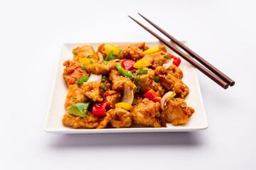 Chilli chicken which is a popular Indo-Chinese starter dish, served on a plate or bowl. Selective focus