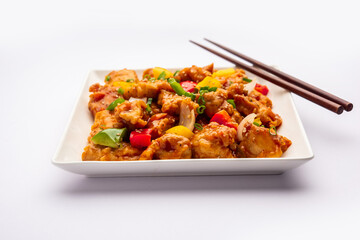 Chilli chicken which is a popular Indo-Chinese starter dish, served on a plate or bowl. Selective focus