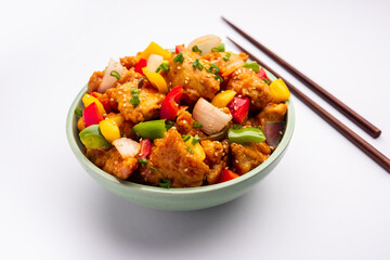 Chilli chicken which is a popular Indo-Chinese starter dish, served on a plate or bowl. Selective focus