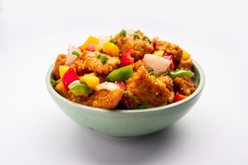 Chilli chicken which is a popular Indo-Chinese starter dish, served on a plate or bowl. Selective focus