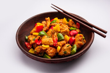 Chilli chicken which is a popular Indo-Chinese starter dish, served on a plate or bowl. Selective focus