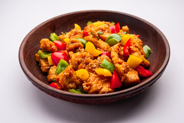 Chilli chicken which is a popular Indo-Chinese starter dish, served on a plate or bowl. Selective focus