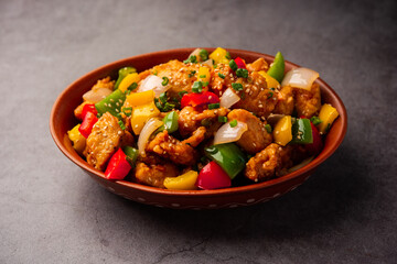 Chilli chicken which is a popular Indo-Chinese starter dish, served on a plate or bowl. Selective focus