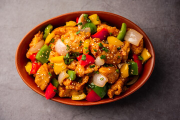 Chilli chicken which is a popular Indo-Chinese starter dish, served on a plate or bowl. Selective focus