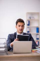Young male employee working in the office