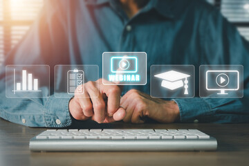 Webinar e-learning training business internet technology concept. Person hand using laptop computer and smart phone with VR screen webinar icon on office desk.