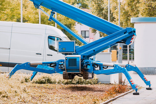 Industrial telescopic unmanned crane standing on hydraulic support legs like a spider at a construction site