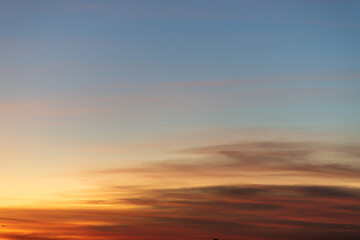 The dramatic colors of the sunset in the sky gradient from blue to orange.