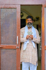 Indian farmer showing money at home.