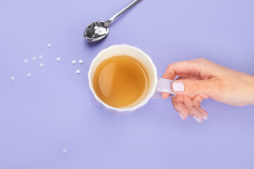 Tea cup with suagr substitute on color background.