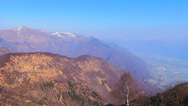 Lepontine Alps in haze from Cimetta Mountain top, Ticino, Switzerland