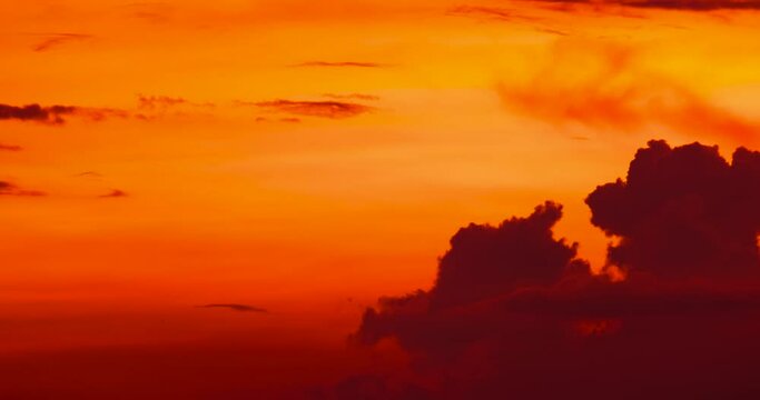 Time lapse of moving lumpy clouds in a golden sunset sky