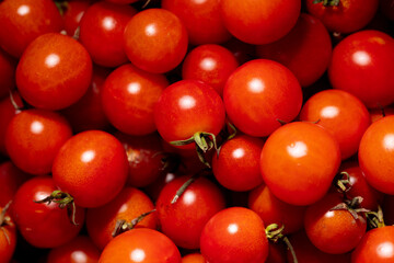 Red cherry tomatoes as background.