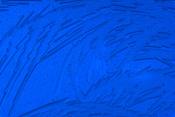 Drawings of ice on blue glass.