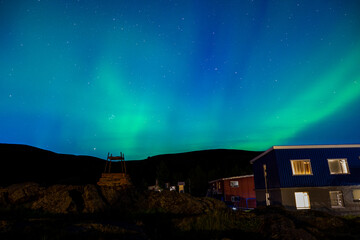Aurora Borealis (Northern Lights) over small houses in Myvatn, Iceland