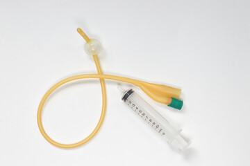 Urinary catheter with syringe 10 ml on a white background, test