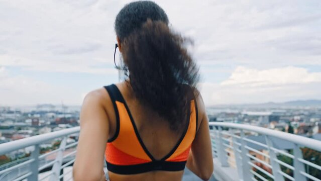 Running on bridge, black woman and fitness with runner in urban city, exercise and healthy active lifestyle. Athlete back view, run outdoor for cardio and training for marathon or race with workout.