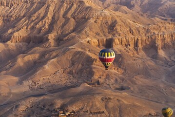 Aerial shot of hot air balloons ride over the valley on a sunny day in Egypt