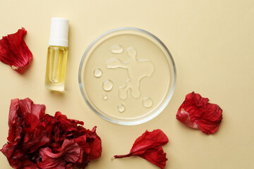 Petri dish with cosmetic product and flowers on beige background, flat lay