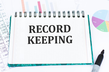 RECORD KEEPING text written on paper folder and charts