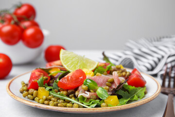 Plate of salad with mung beans on white table
