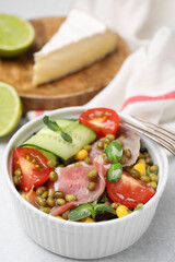 Bowl of salad with mung beans on white table, closeup