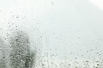 Window glass with raindrops as background, closeup