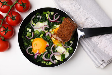Tasty shakshuka with piece of bread isolated on white table, flat lay