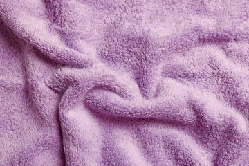 Fototapeta na wymiar Soft crumpled pale purple towel as background, top view