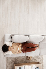 Above view, black woman and sofa of a person on phone wifi looking at web and social media app. Living room lounge couch of a woman using mobile technology to relax at home in the morning on internet