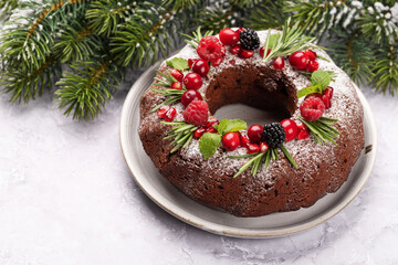 Christmas cake with pomegranate seeds, cranberries and rosemary