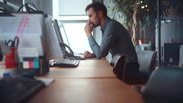 worker uses a landline phone to answer