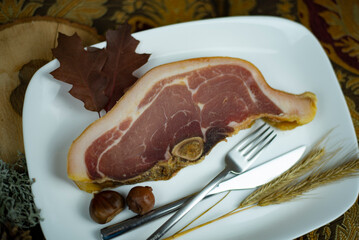 Dried bacon on a plate.  Dried pork steak. Dried pork meat. Typical Bulgarian famous dried pork meat produced in Elena's region.