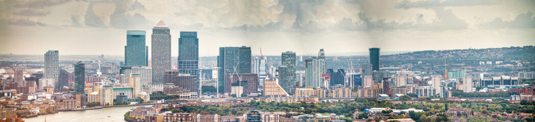 London - UK. Aerial panoramic view of Canary Wharf modern buildings on a cloudy day - obrazy, fototapety, plakaty