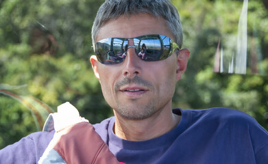 Portrait of a happy caucasian man relaxing during a hike in the forest