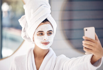 Woman, facial mask and phone selfie after morning shower, wellness and healthy skincare, makeup product and cleaning in bathroom at home. Beauty, face mask cosmetics and female taking photo on mobile
