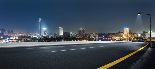 Cairo street at night in Egypt - road in Cairo city with buildings and Cairo tower in Background - 