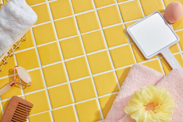  Empty space. Top view for Cosmetic with tower, mirror, and massage brush on the mosaic background