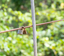 Two small keys, rusted and weathered, were attached to each other on a brown iron wire.