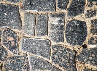 Asphalt paving stone old background with cracks.
